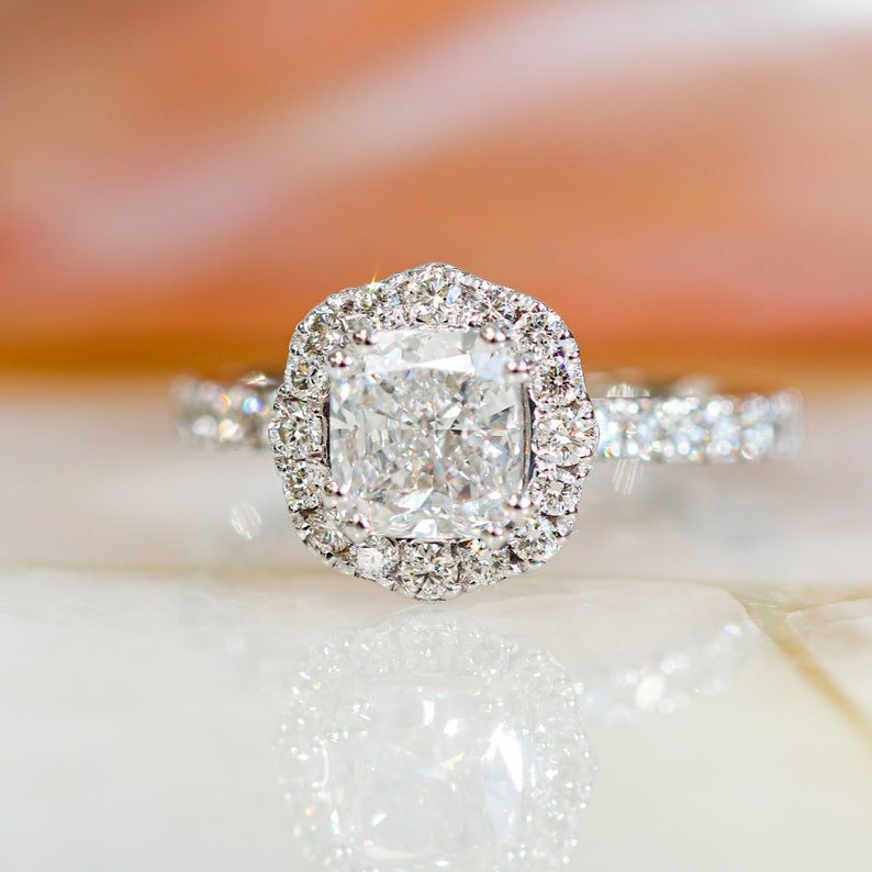 Profile view of cushion cut halo engagement ring band