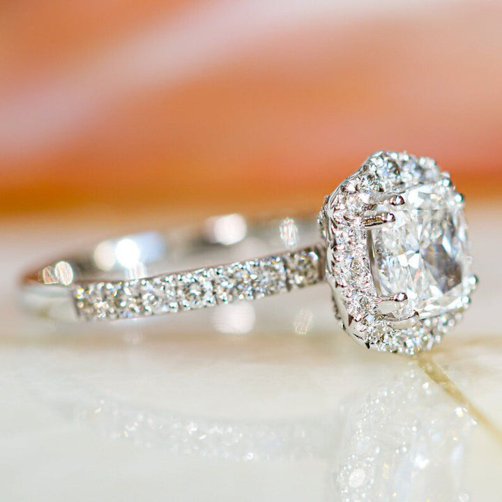 Cushion halo engagement ring viewed from the side