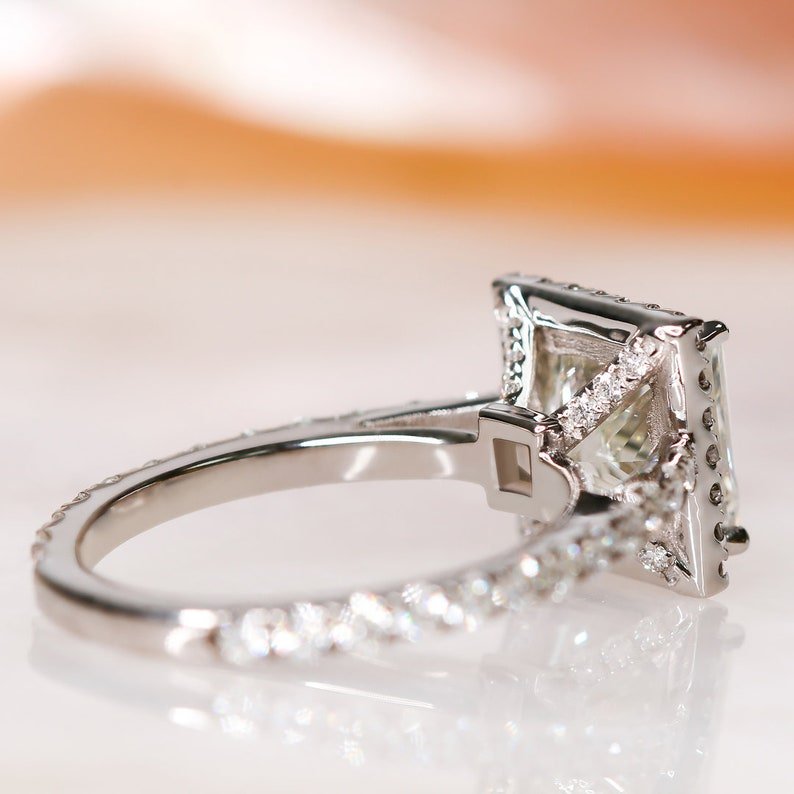 Unboxing view of princess cut halo diamond engagement ring