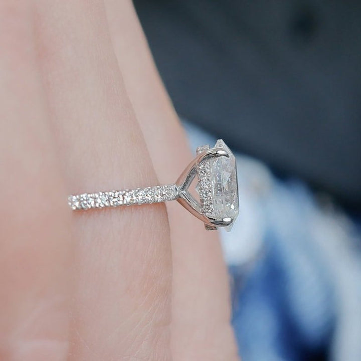 Oval hidden halo engagement ring offered in gold and platinum