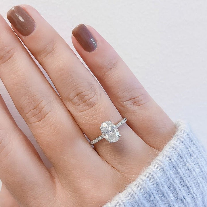 Oval hidden halo ring set with an IGI graded diamond
