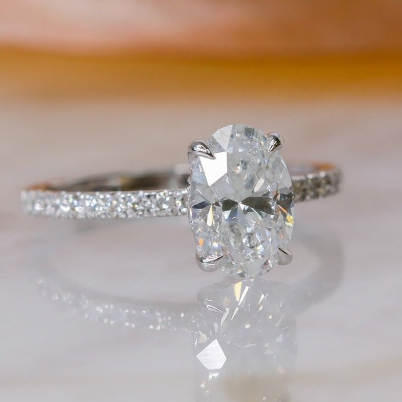 IGI certified oval cut diamond in hidden halo engagement ring setting