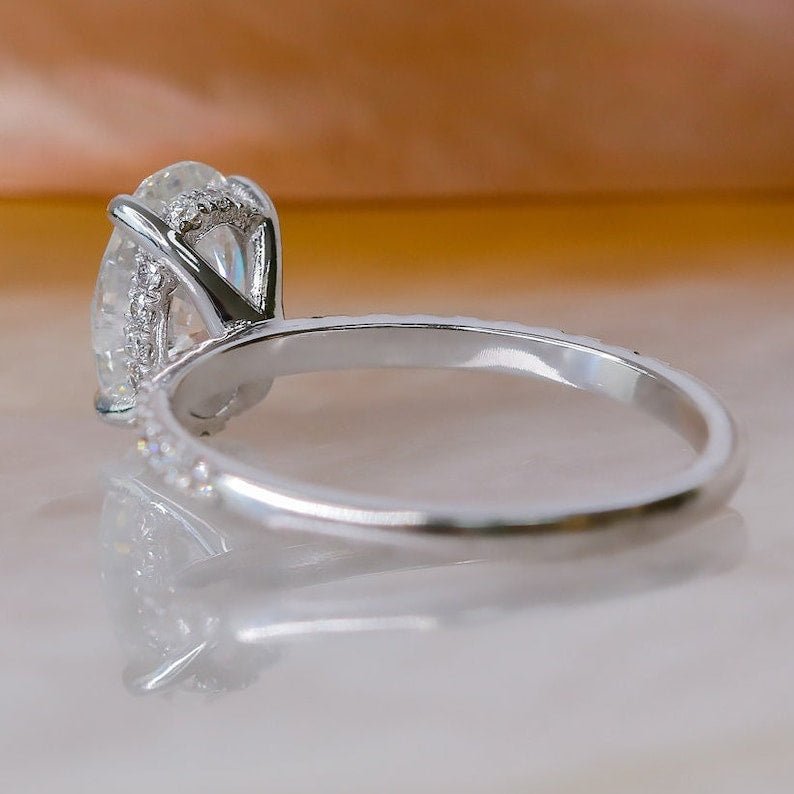 Certified oval cut diamond featured in hidden halo engagement ring