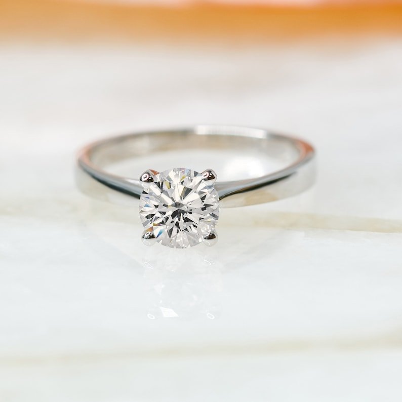 Round solitaire engagement ring with IGI certificate and packaging