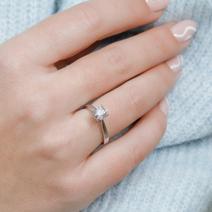 Round solitaire diamond ring presented in signature gift packaging