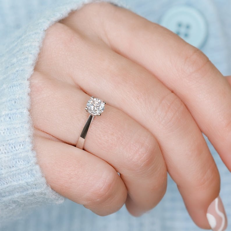 Round cut engagement ring shown with authenticity certificate