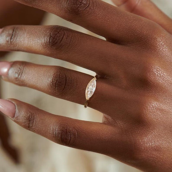 Detailed close-up of marquise solitaire diamond engagement ring