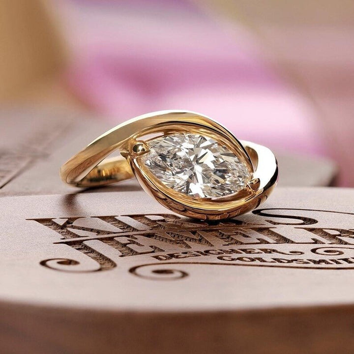 Close-up of marquise cut center diamond in solitaire engagement ring