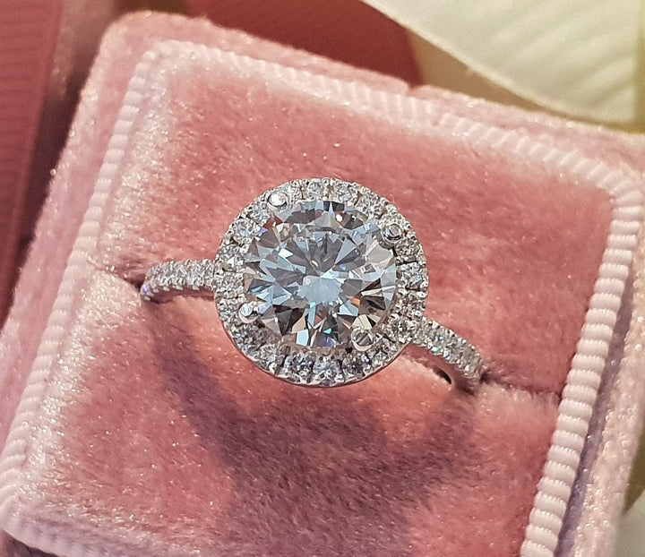 Macro shot of round cut diamond facets in halo ring setting