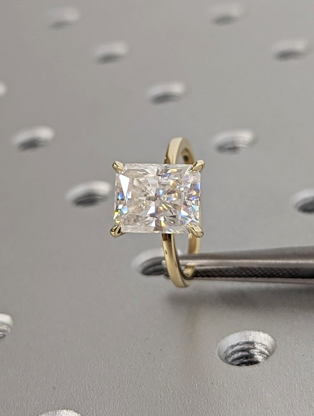 Radiant cut solitaire engagement ring shown in real-life wear