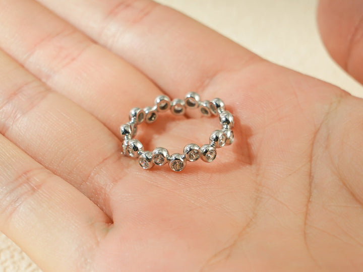 Round diamond band stacked with engagement ring
