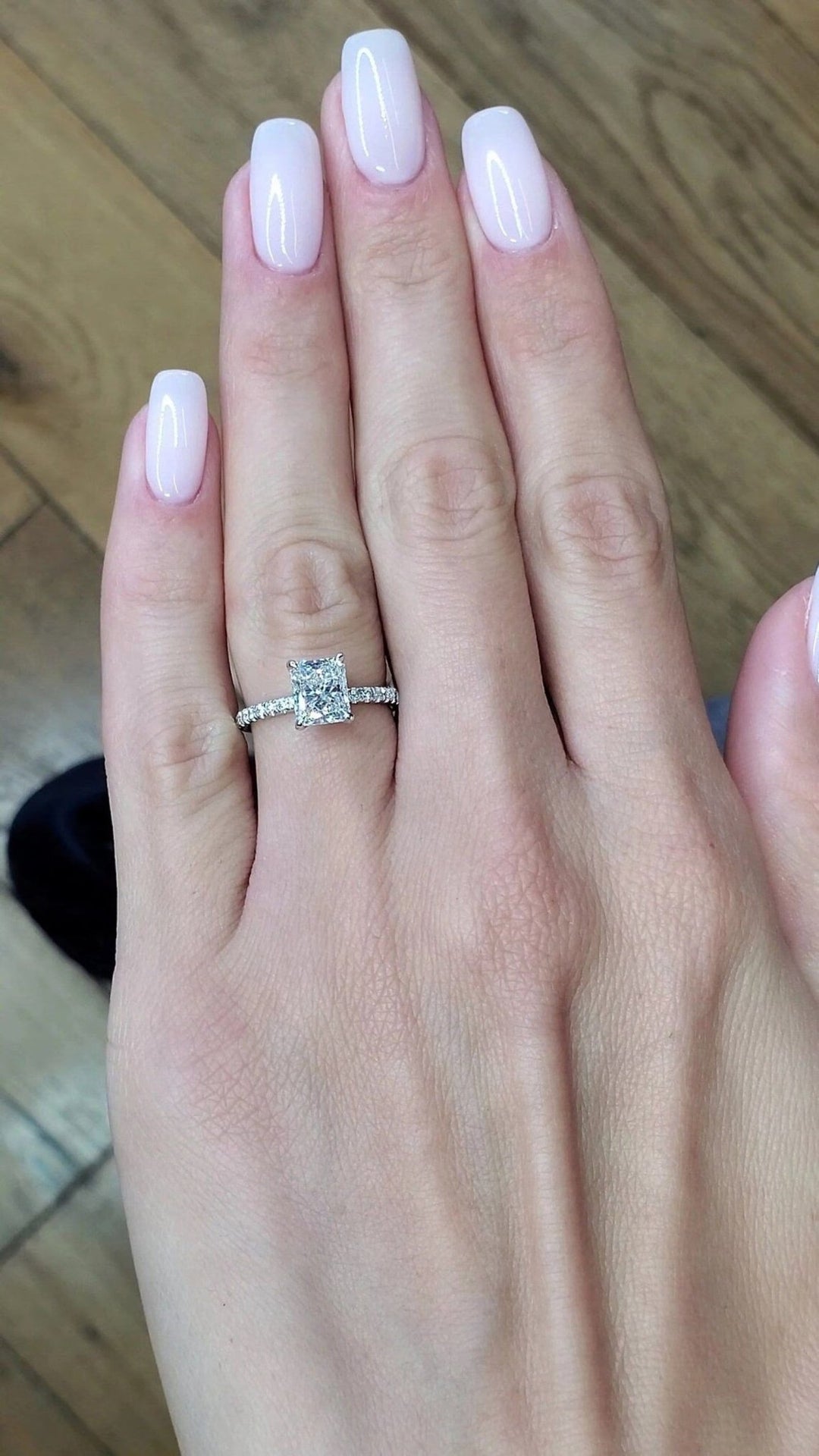 Close-up of radiant cut center diamond in hidden halo engagement ring
