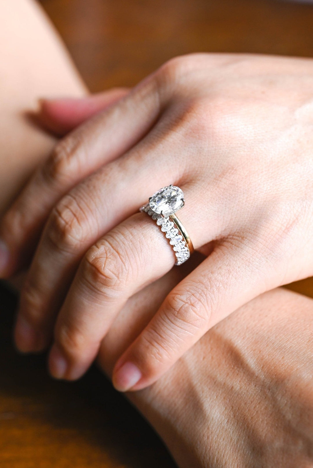 Oval diamond band stacked with engagement ring