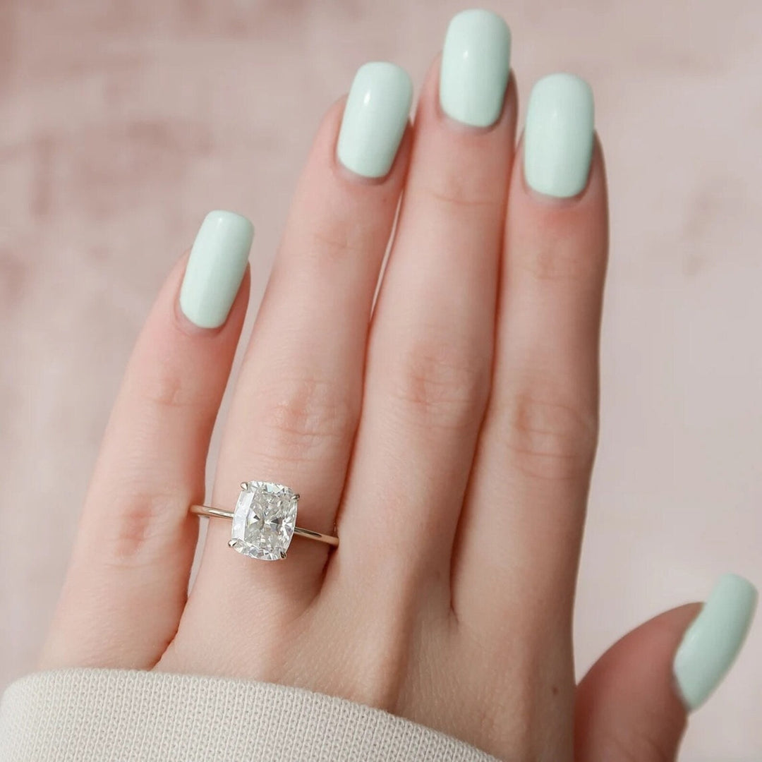 Lifestyle shot of cushion hidden halo diamond ring on hand