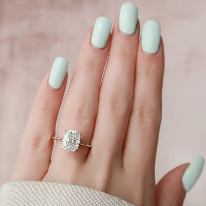 Lifestyle shot of cushion hidden halo diamond ring on hand