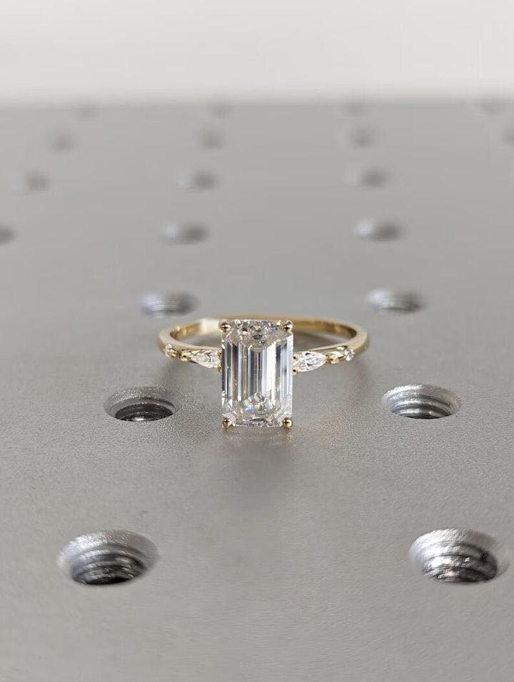 Unboxing view of emerald cut cluster diamond engagement ring