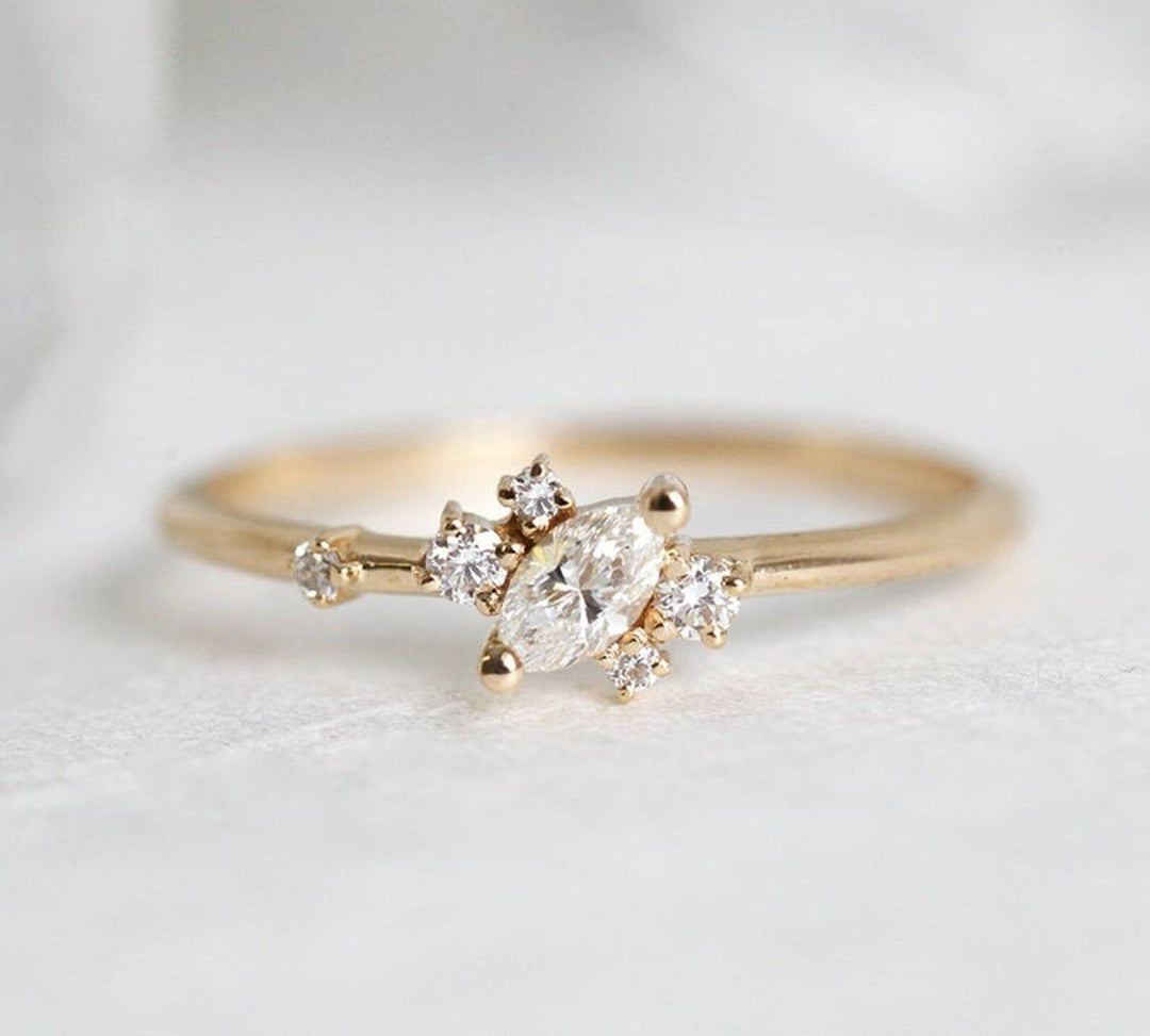 Marquise cut cluster engagement ring shown in real-life wear