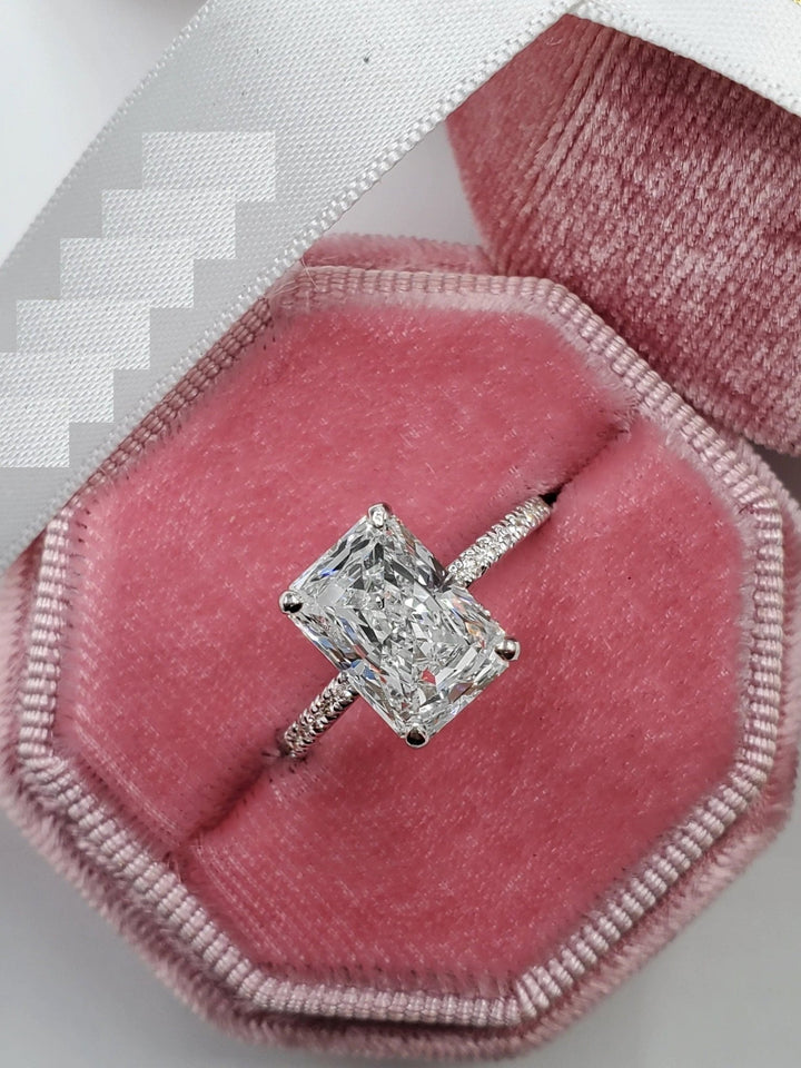 Radiant hidden halo ring set with an IGI graded diamond