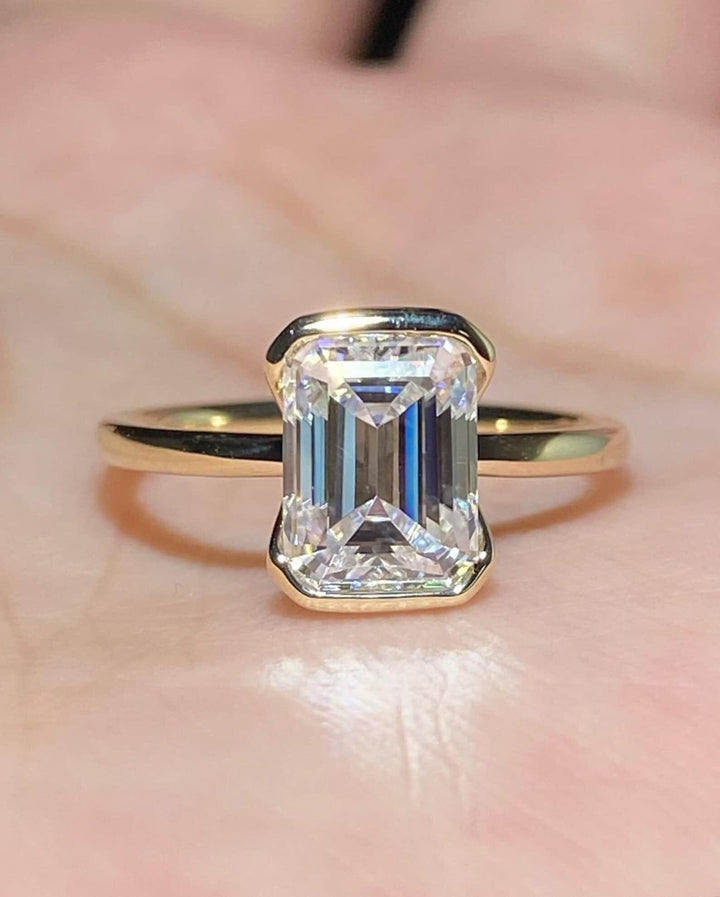Emerald cut bezel engagement ring shown in real-life wear