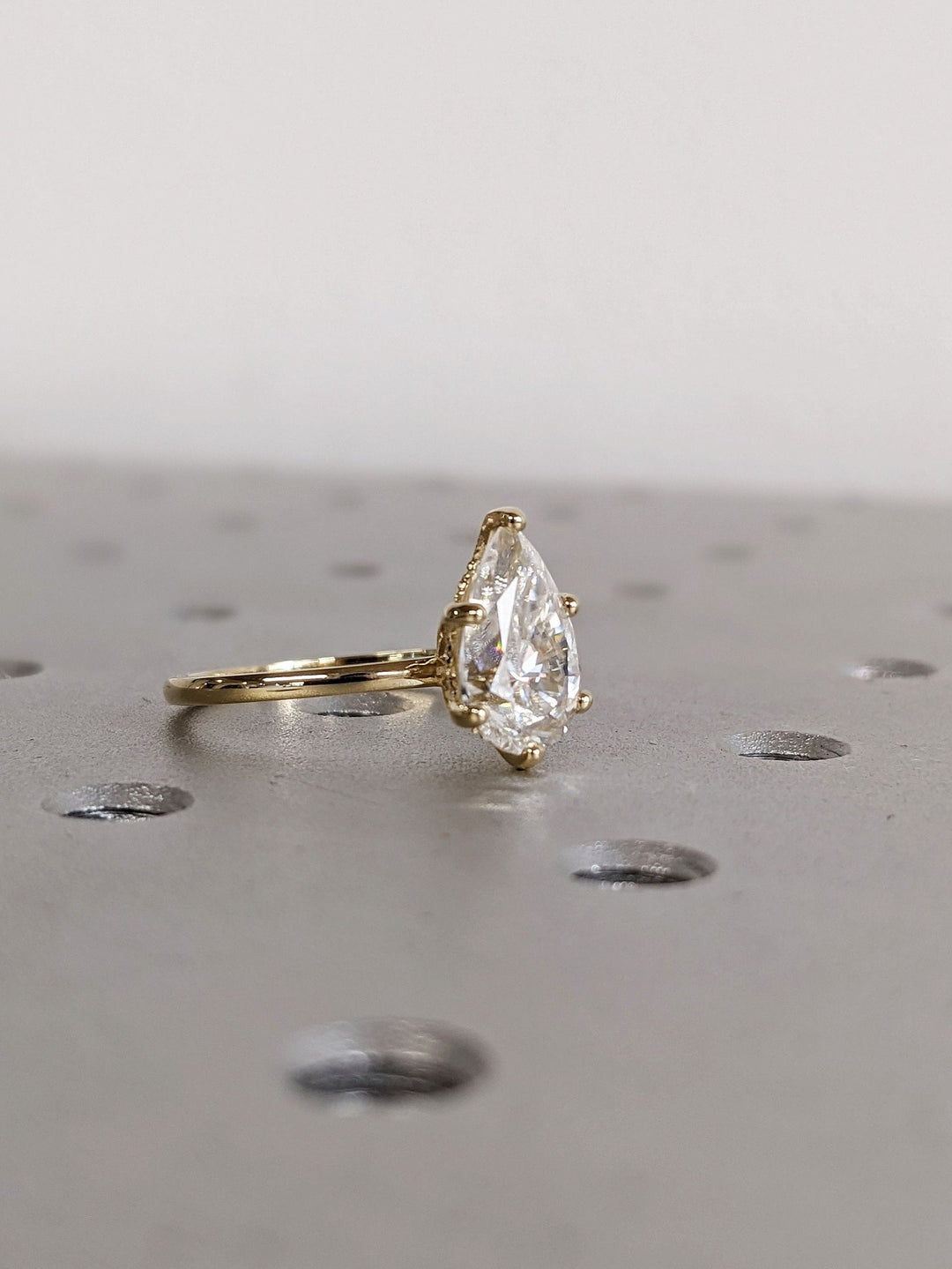 Pear hidden halo engagement ring with brilliant diamond sparkle