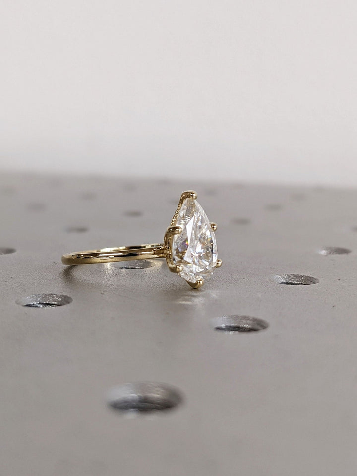 Pear hidden halo engagement ring with brilliant diamond sparkle
