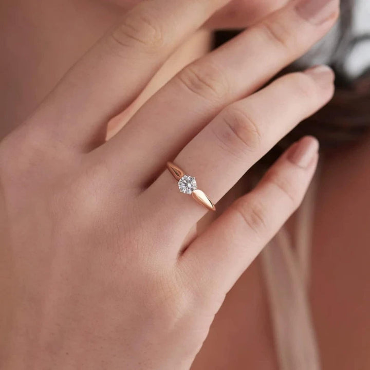 Round solitaire engagement ring shown on hand for true-to-life sizing