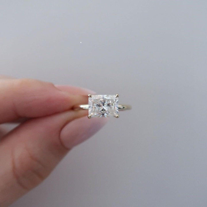 Radiant east west lab grown diamond ring fitted on finger