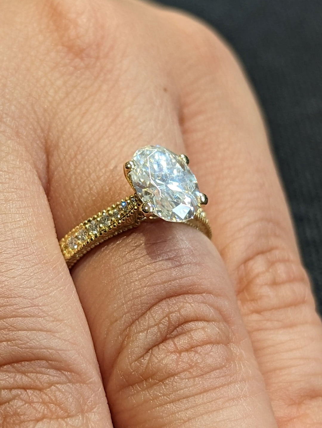 Oval vintage lab grown diamond ring fitted on finger