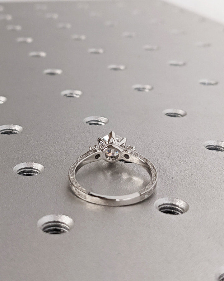 Round three stone lab grown diamond ring side profile in gold setting