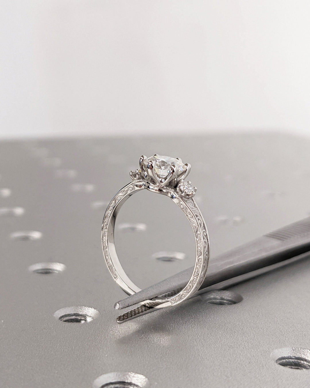 Round cut engagement ring side view showing band detail