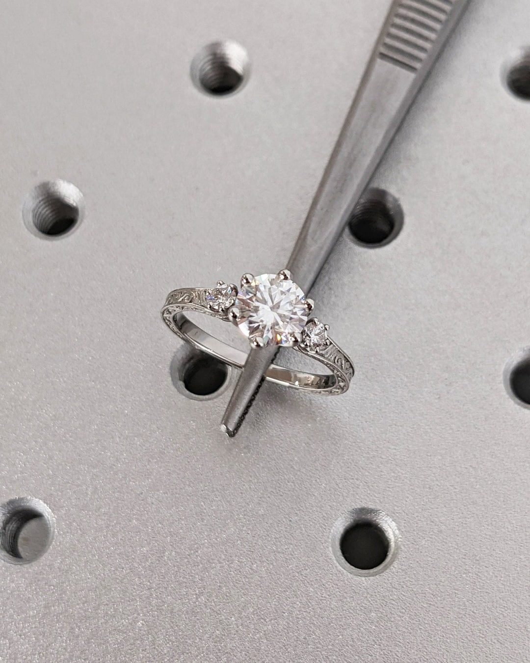 Side angle of round three stone diamond engagement ring