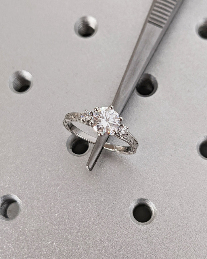 Side angle of round three stone diamond engagement ring