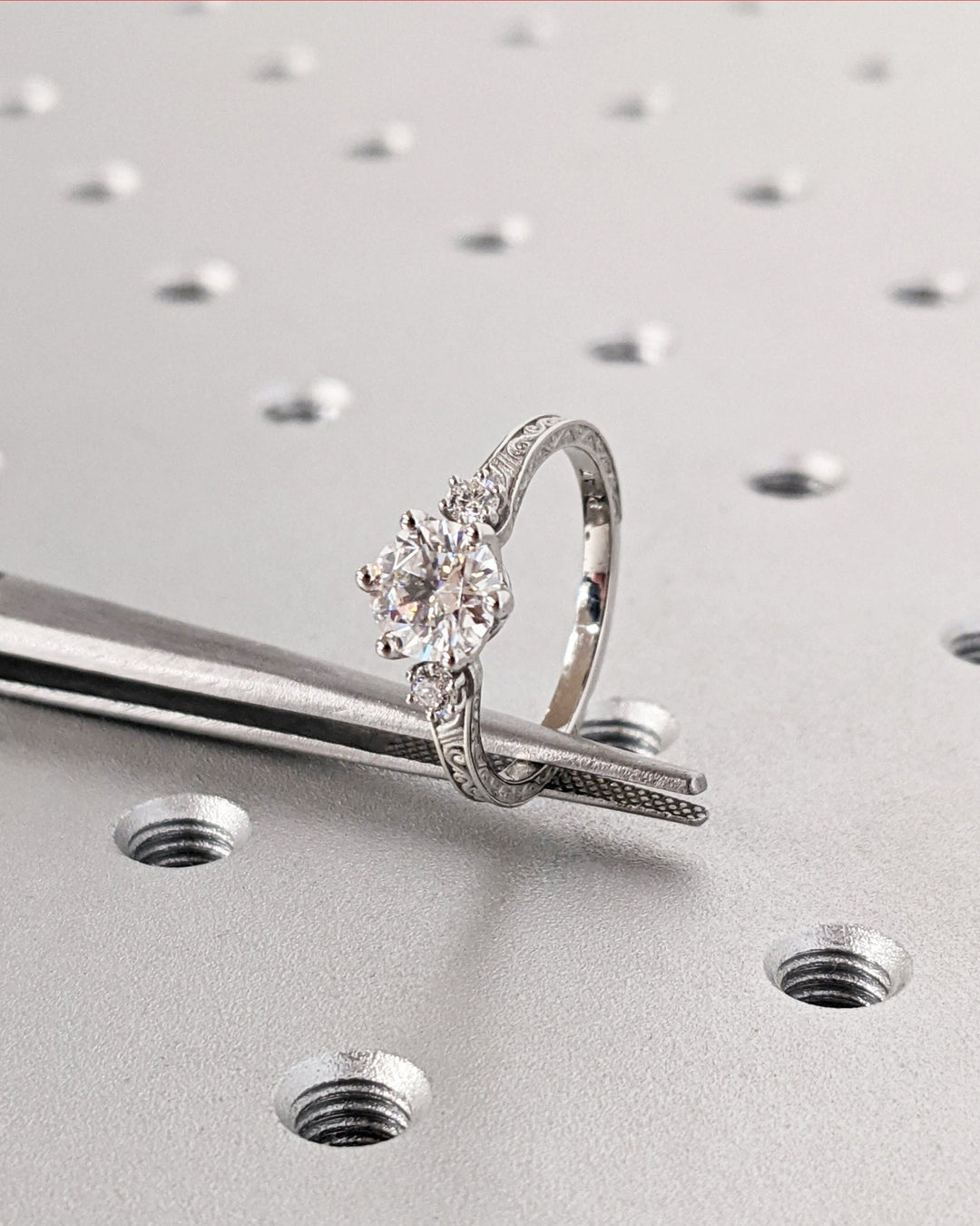 Round three stone lab grown diamond ring fitted on finger