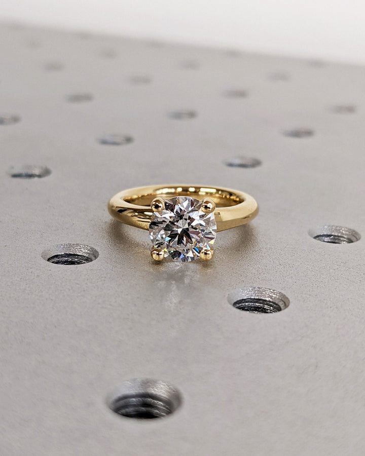 Round solitaire engagement ring close-up highlighting diamond sparkle
