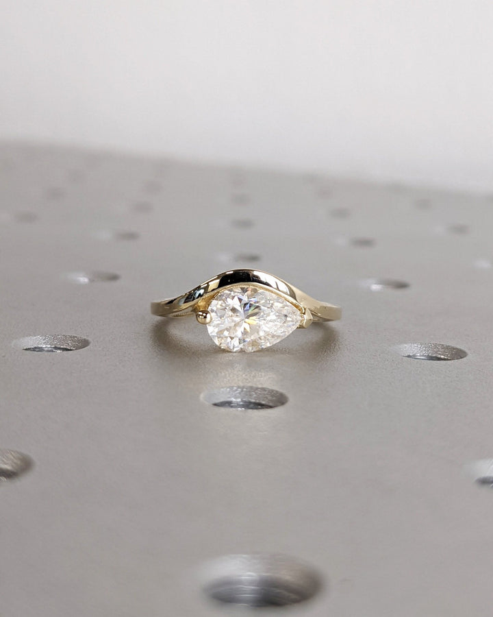 Unboxing view of pear cut solitaire diamond engagement ring