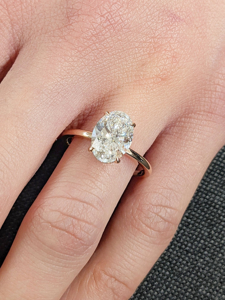 Oval cut diamond ring worn on hand