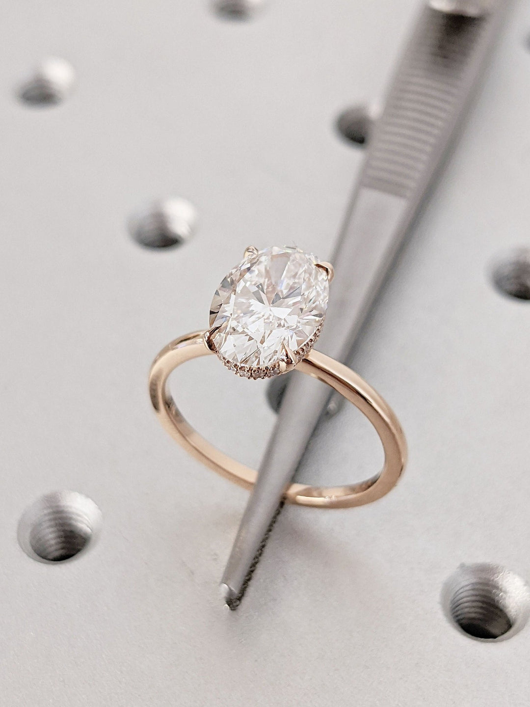 Oval cut hidden halo engagement ring with IGI certified center diamond
