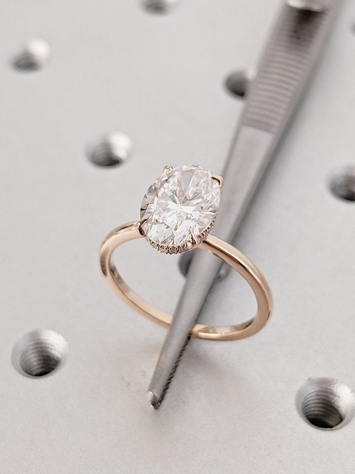 Oval cut hidden halo engagement ring with IGI certified center diamond