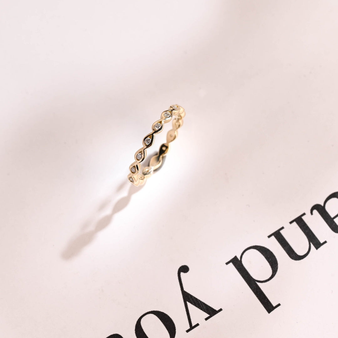Round diamond wedding band in rose gold