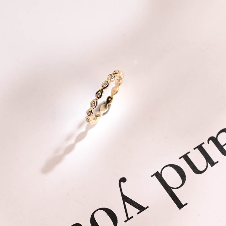 Round diamond wedding band in rose gold