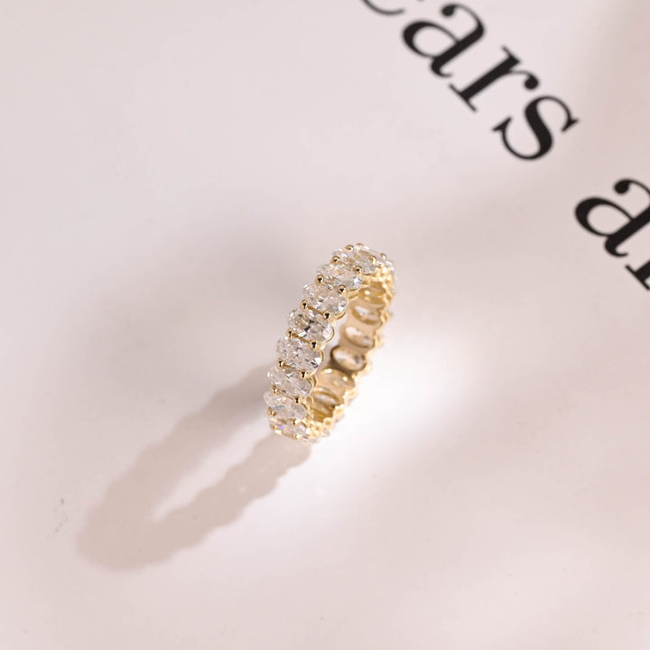 Oval diamond band stacked with engagement ring