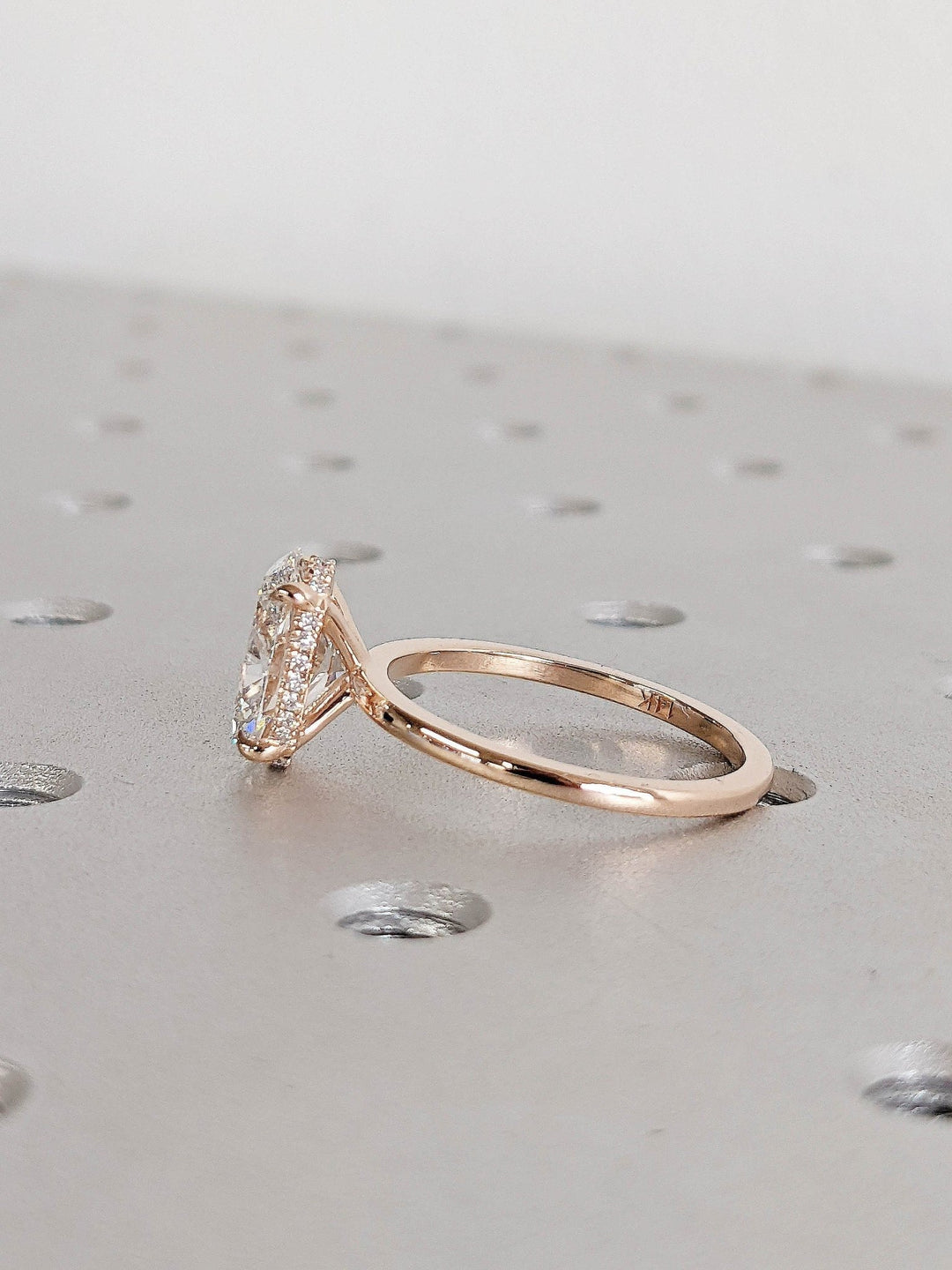 Oval cut hidden halo engagement ring shown in real-life wear