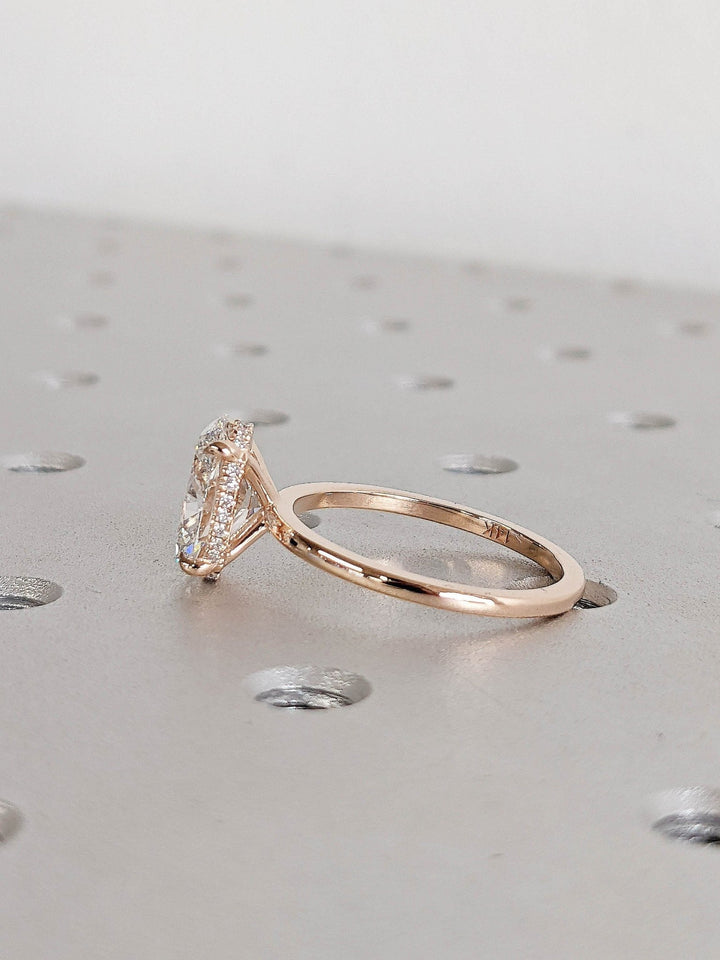 Oval cut hidden halo engagement ring shown in real-life wear