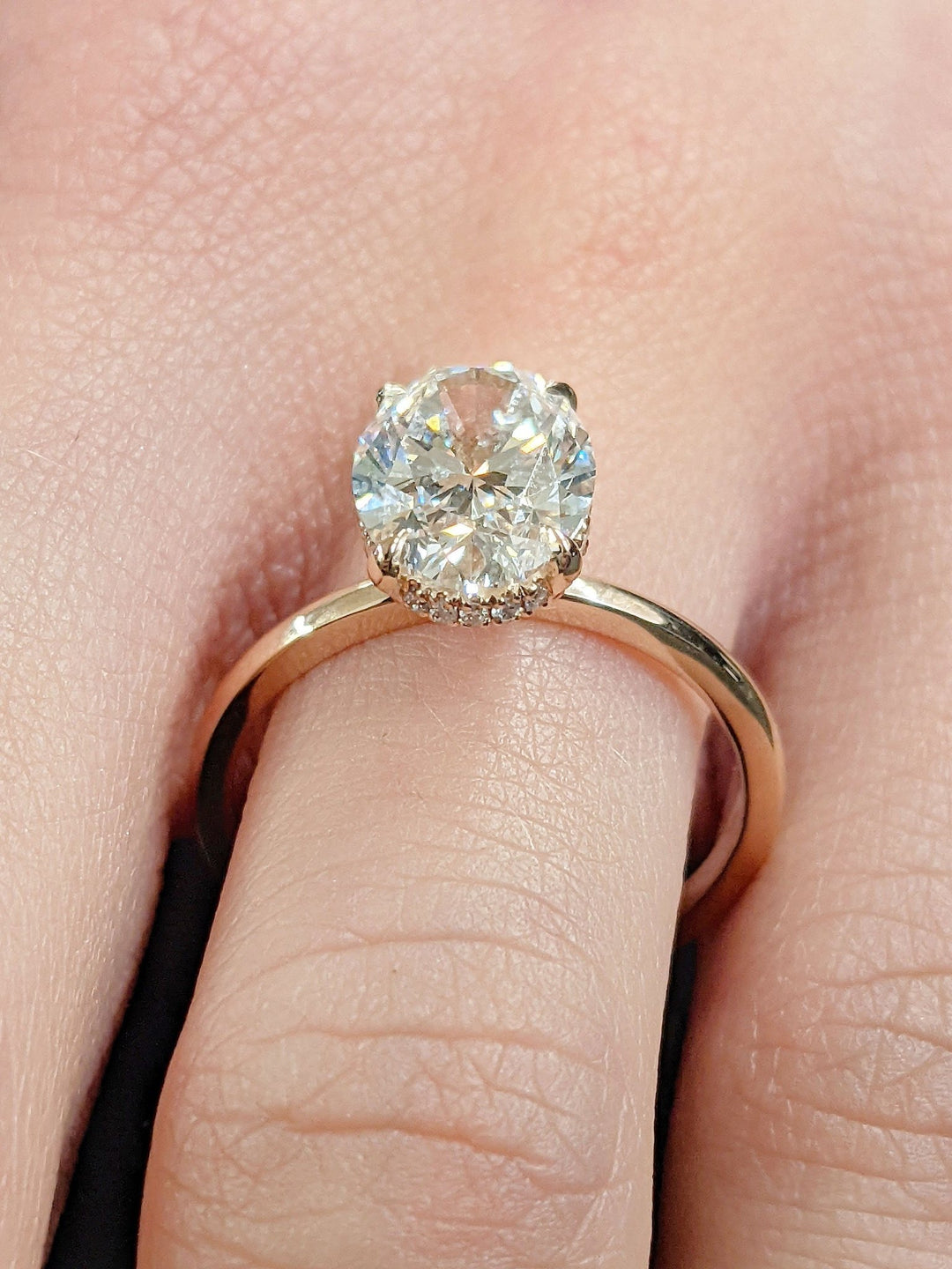 IGI certified oval cut diamond in hidden halo engagement ring setting