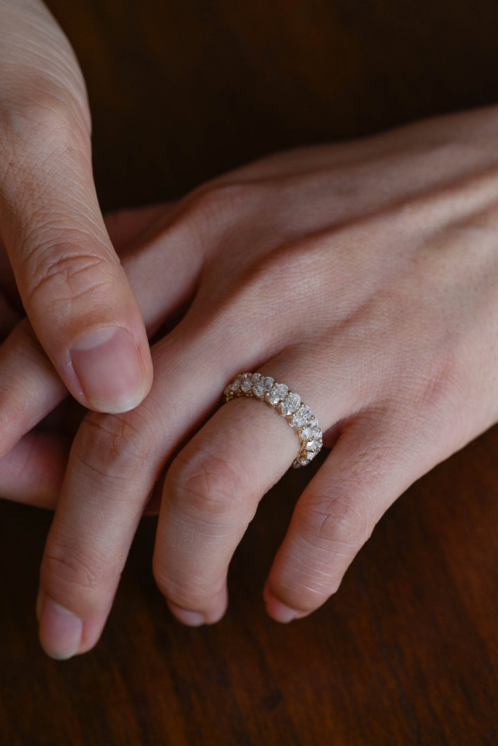 Side view of oval diamond wedding band