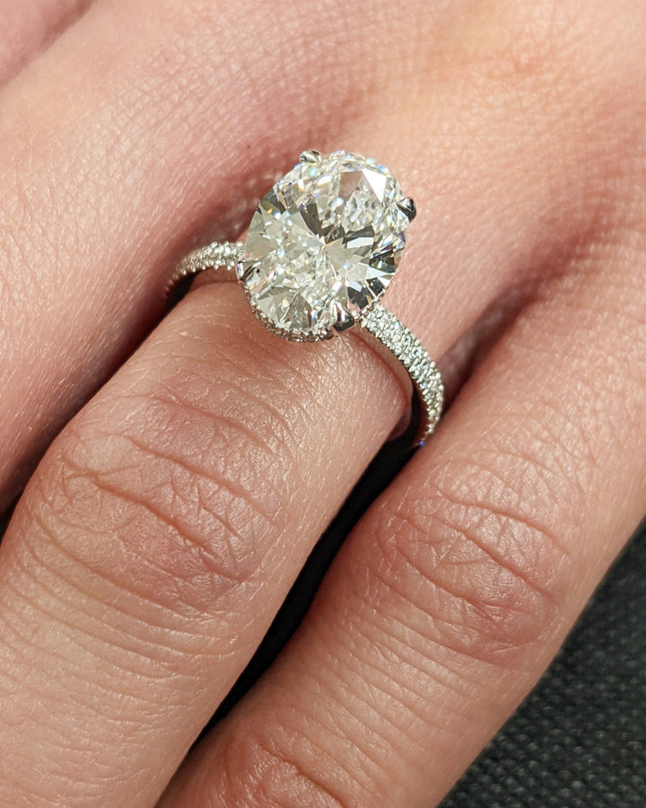 Oval hidden halo diamond engagement ring available in multiple metals