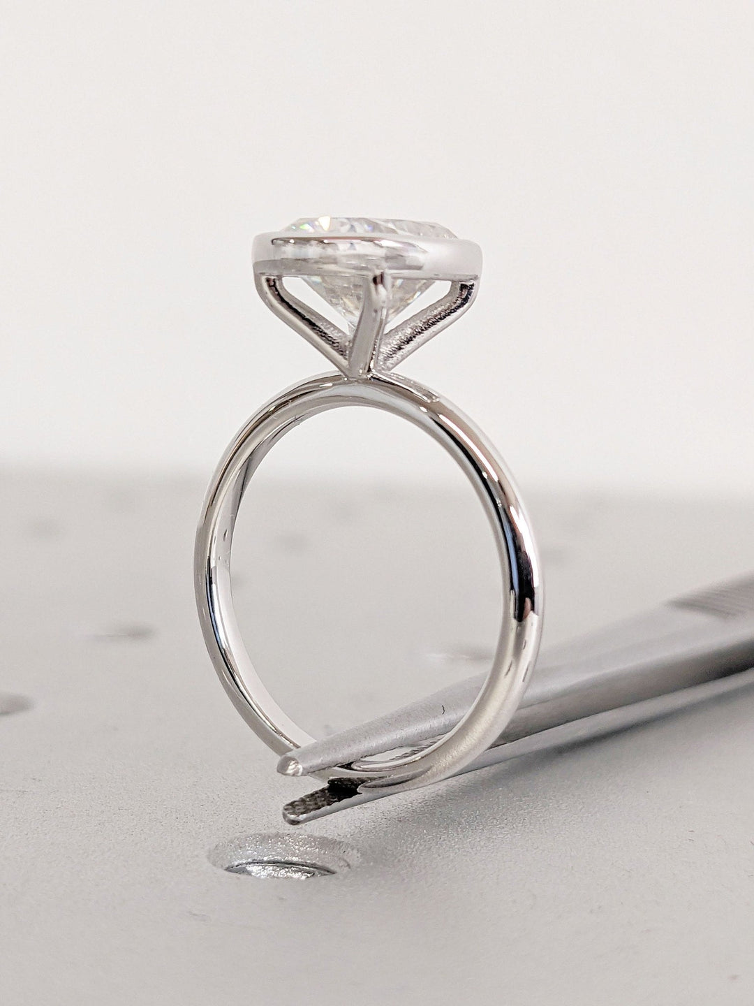 Cushion bezel engagement ring close-up showing high clarity diamond clarity