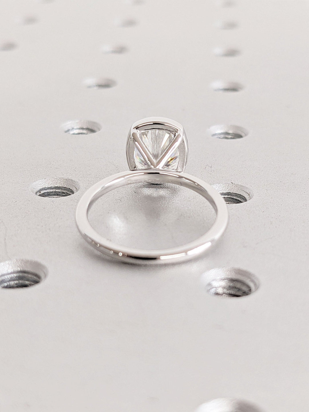 Cushion bezel engagement ring close-up highlighting diamond sparkle