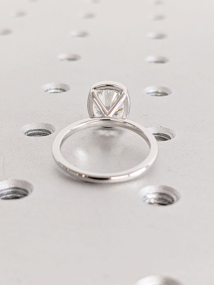 Cushion bezel engagement ring close-up highlighting diamond sparkle