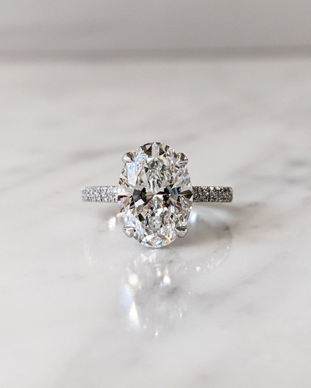 Oval hidden halo engagement ring with IGI certificate and packaging